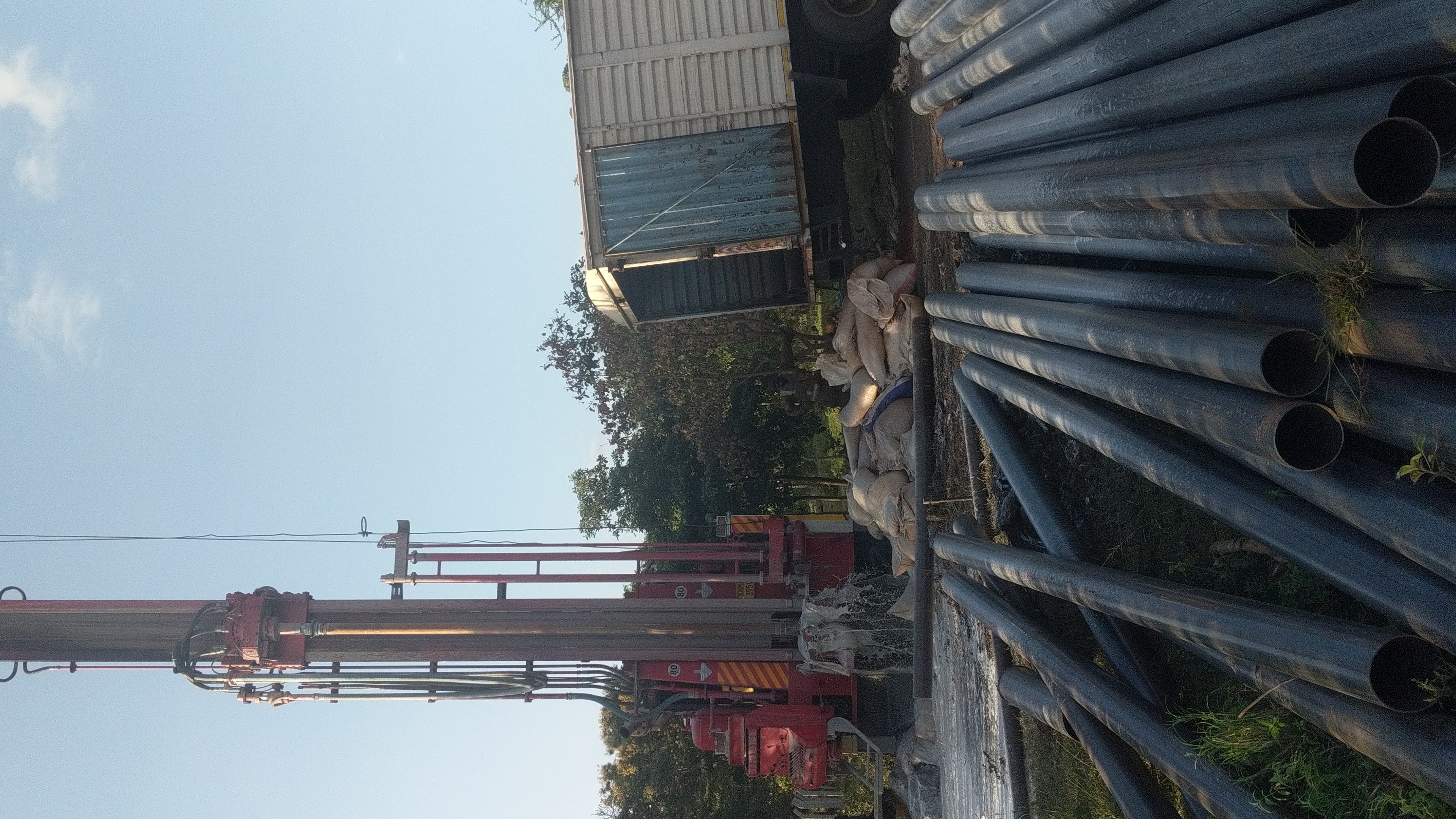 Completed borehole with pump and water flowing